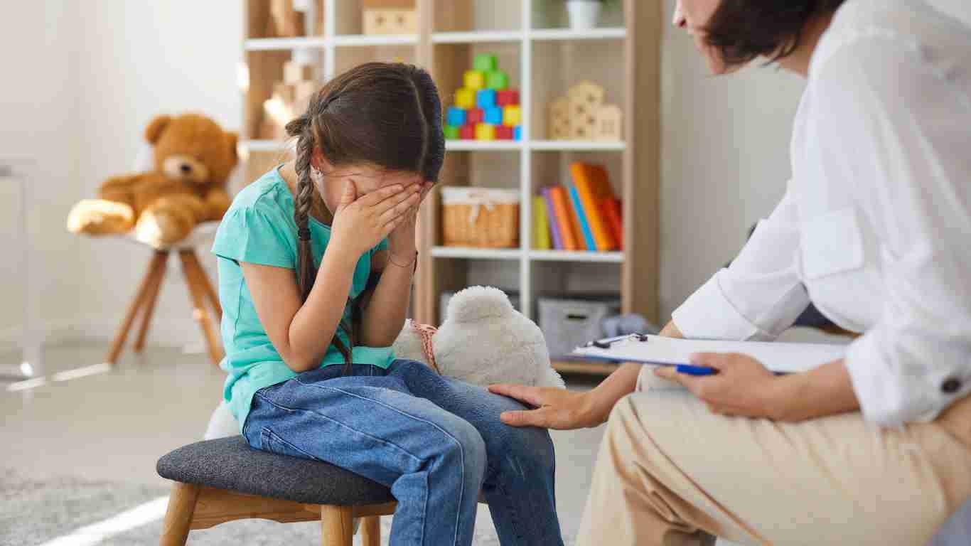 A little girl crying during a therapy session