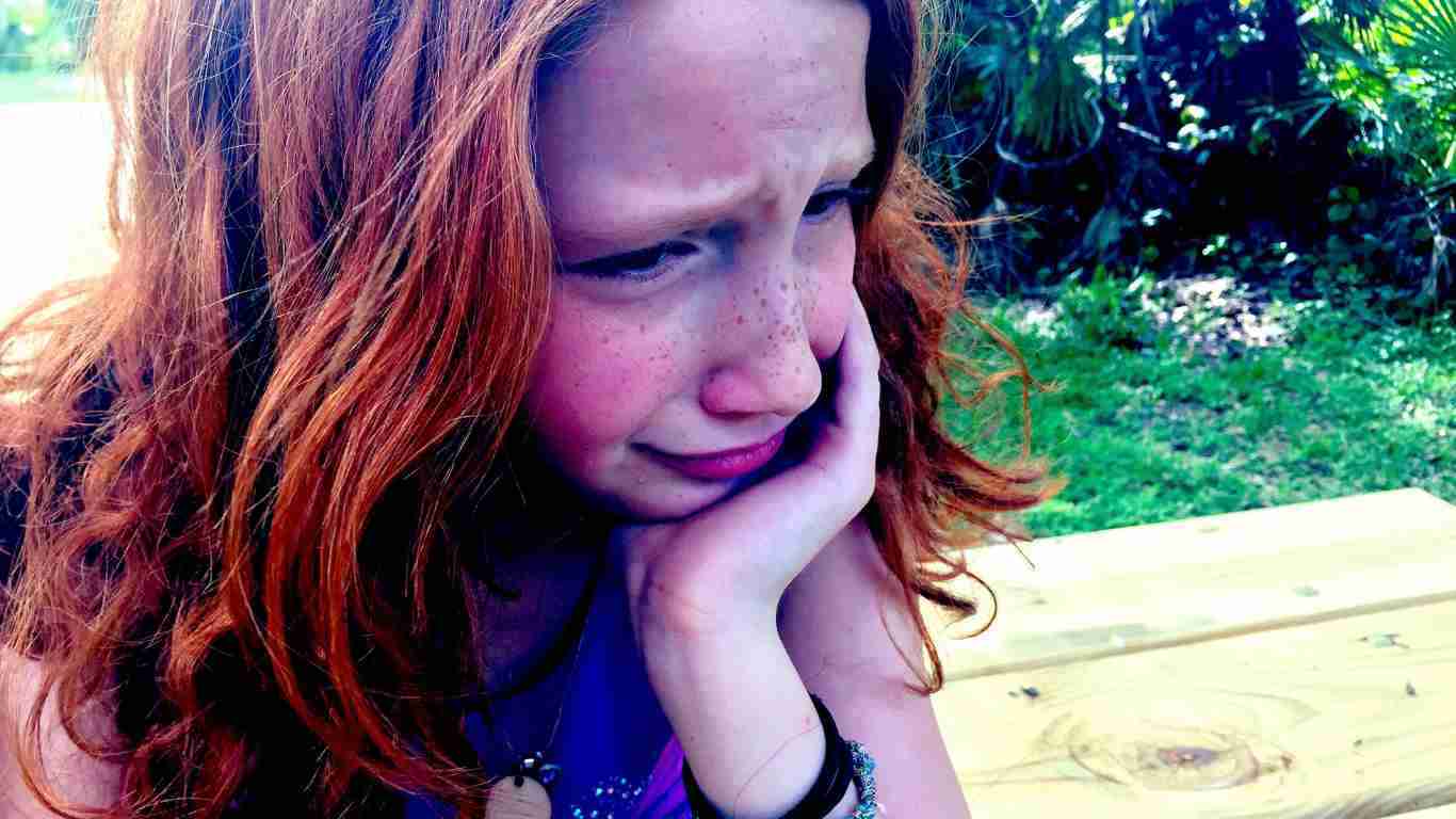 A young girl crying disconsolately