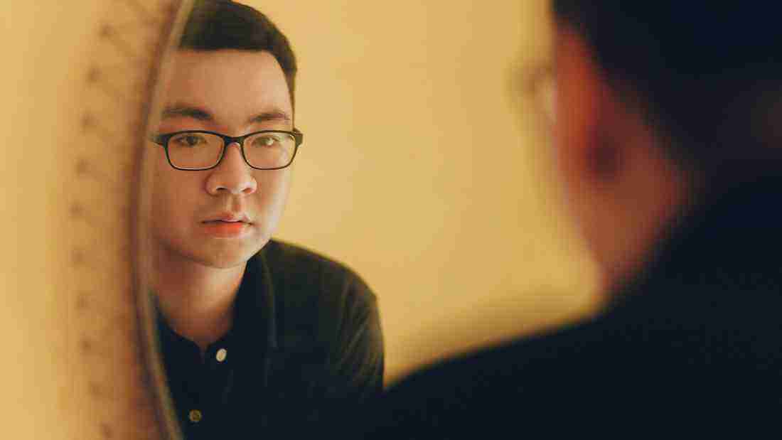 A man gazing in a mirror