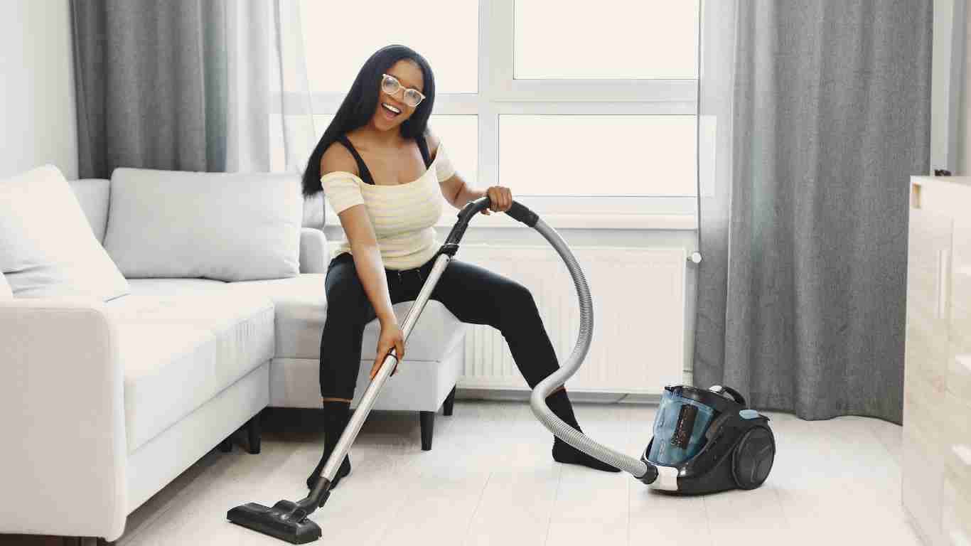 A woman using a vacuum cleaner