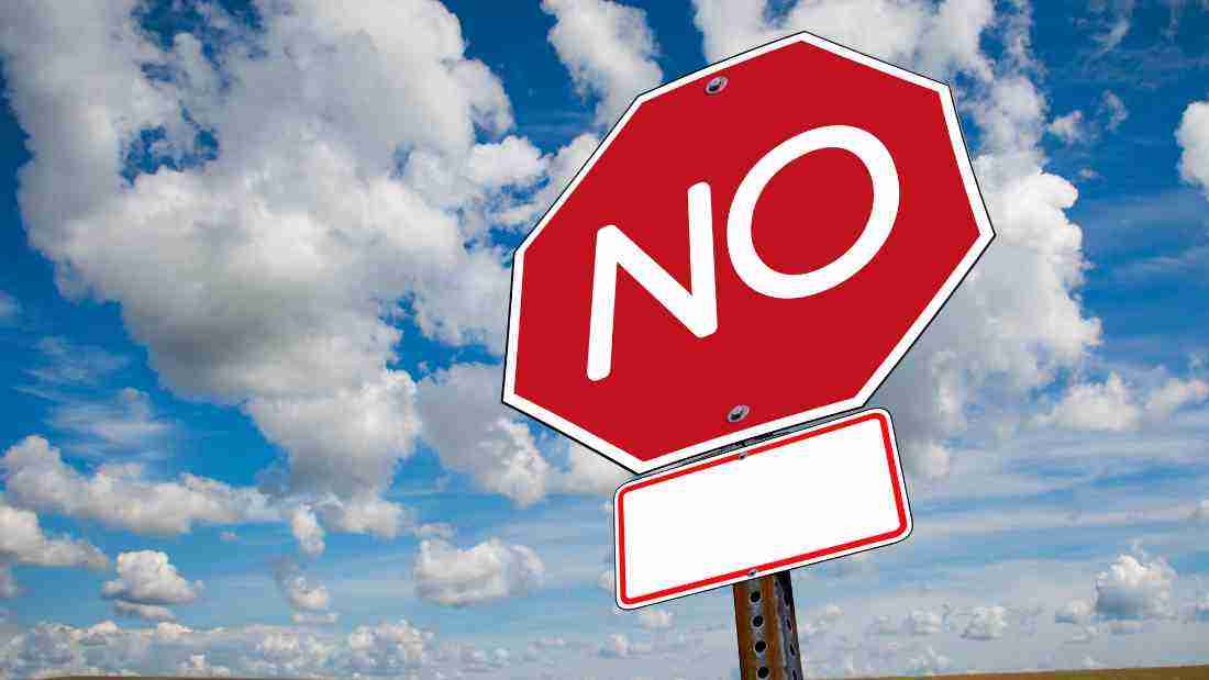 A road sign with the word NO