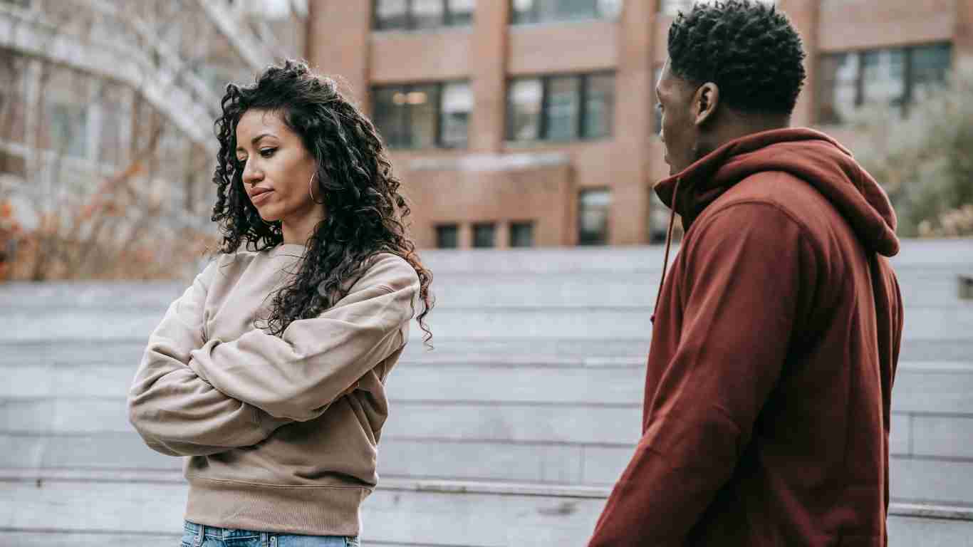 A young woman giving her boyfriend the silent treatment