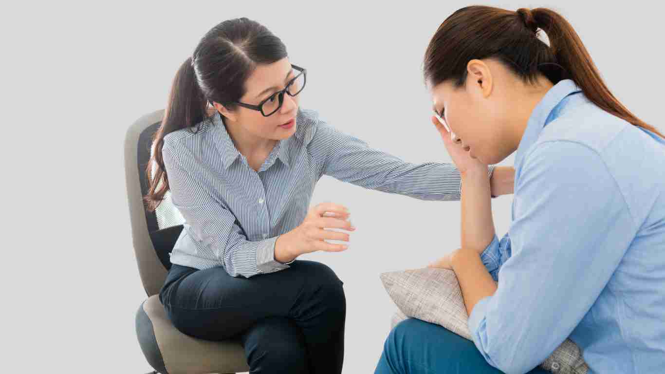 A therapist comforting her client, who appears to be very upset