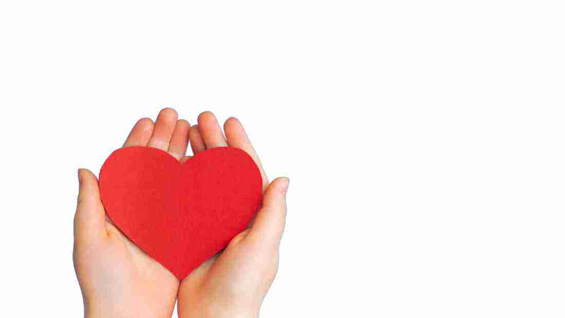 A woman holding a heart in her hands
