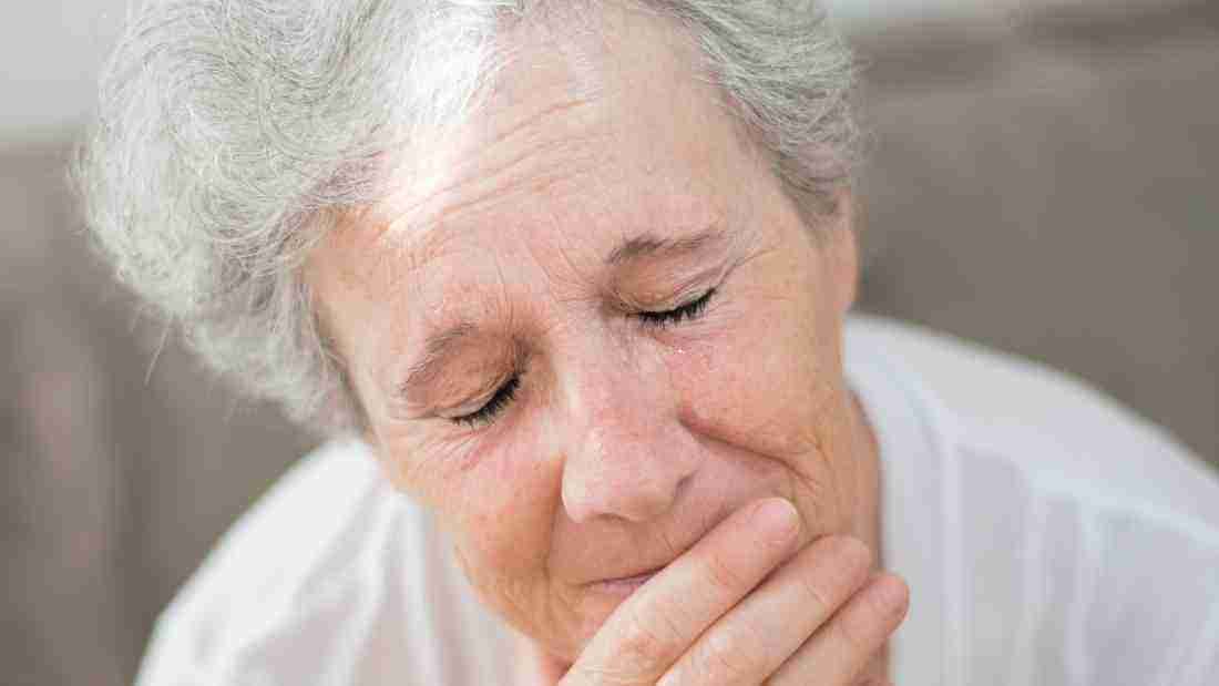An old lady with tears going down her face