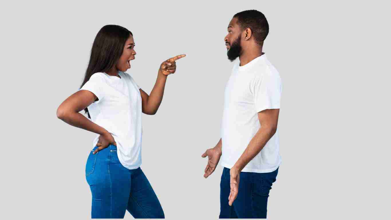 A woman shouting and pointing aggressively at her partner