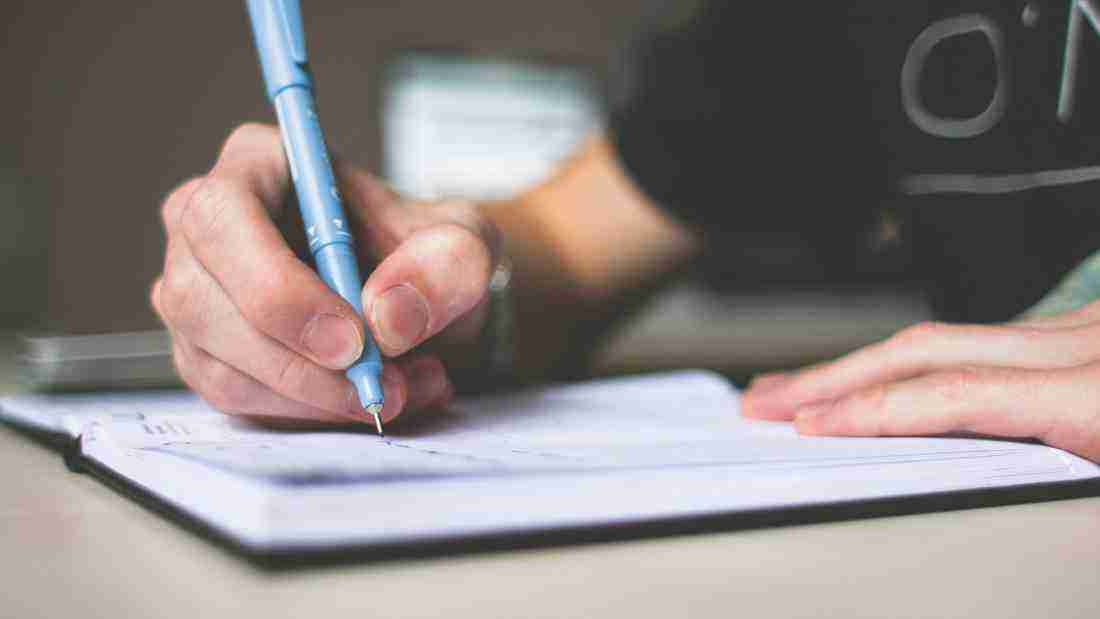 Someone writing in a journal