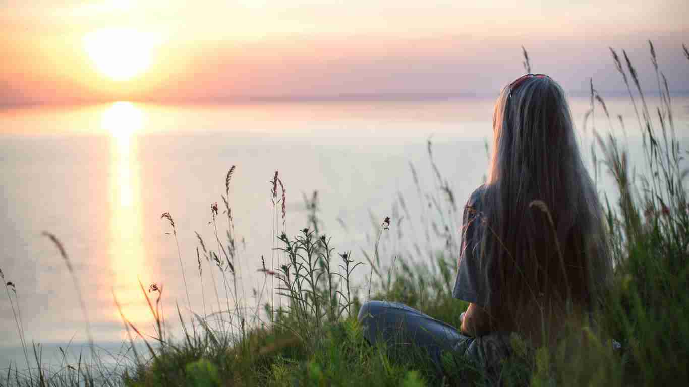 A woman enjoying a lovely sunrise