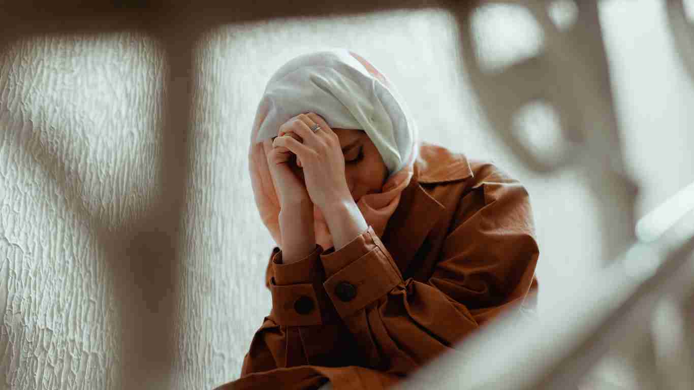 A lonely girl crying in a stairwell