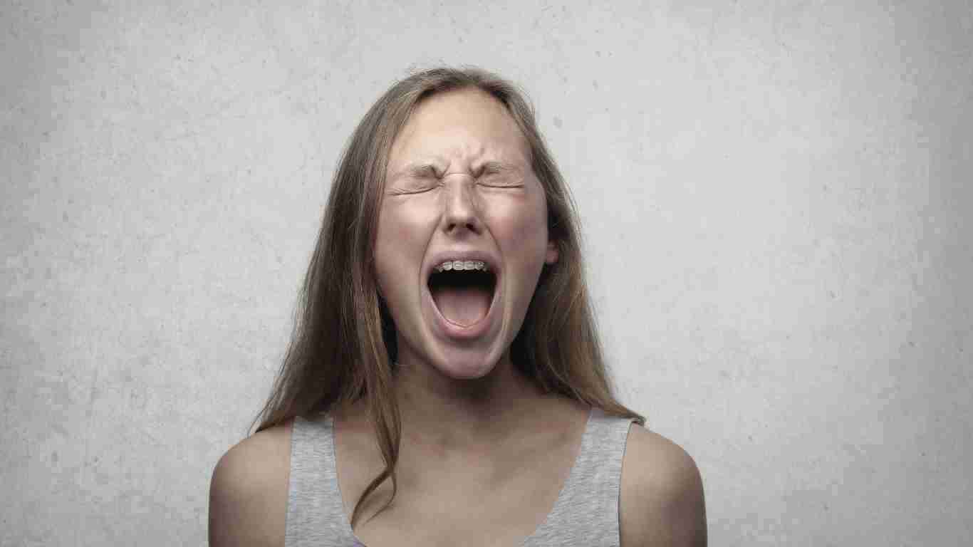 A woman screaming with rage