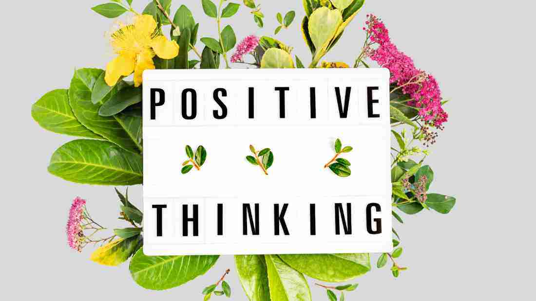 A bouquet of flowers with Positive Thinking written on a note