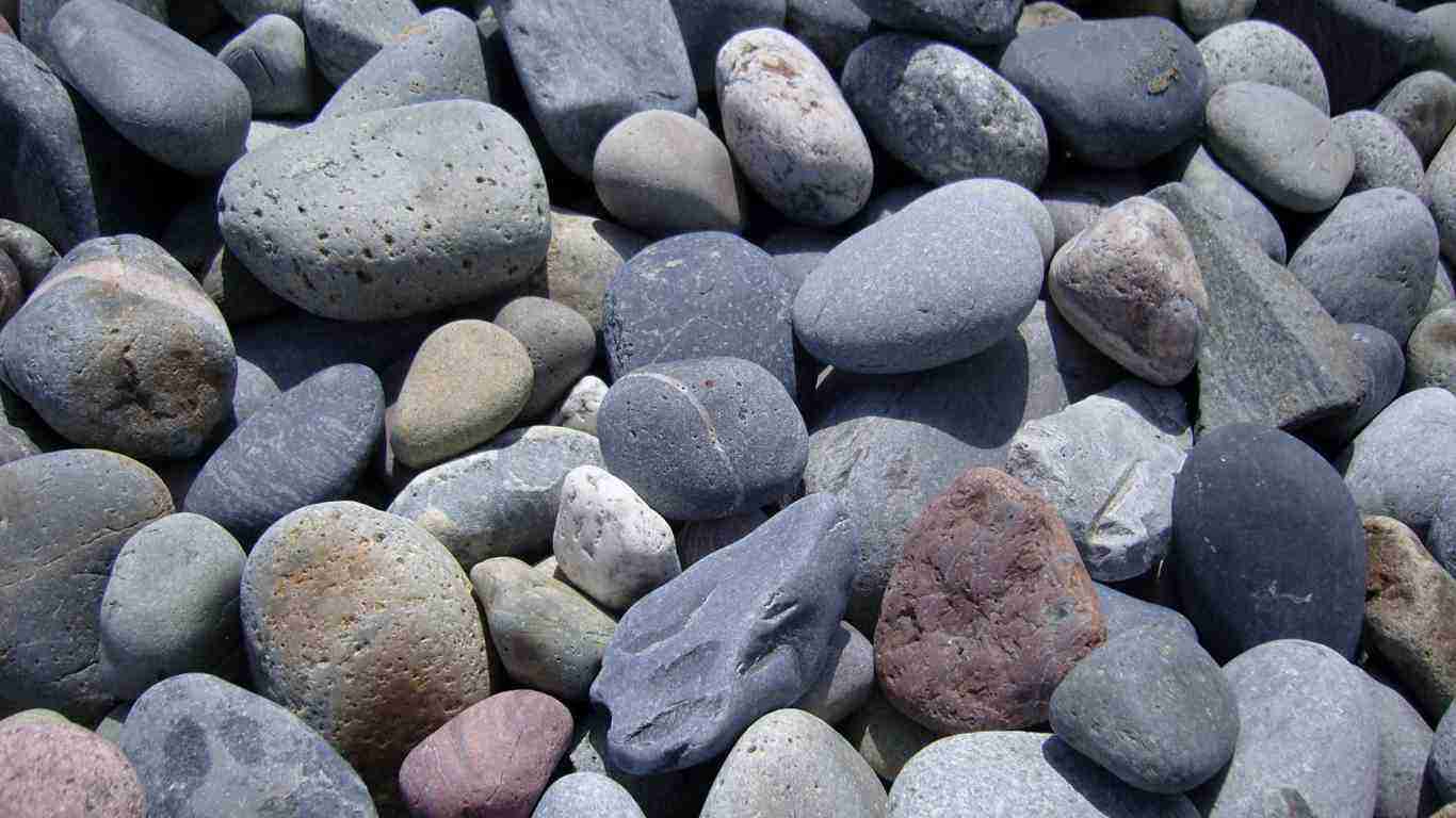 A pile of grey pebbles at the beach