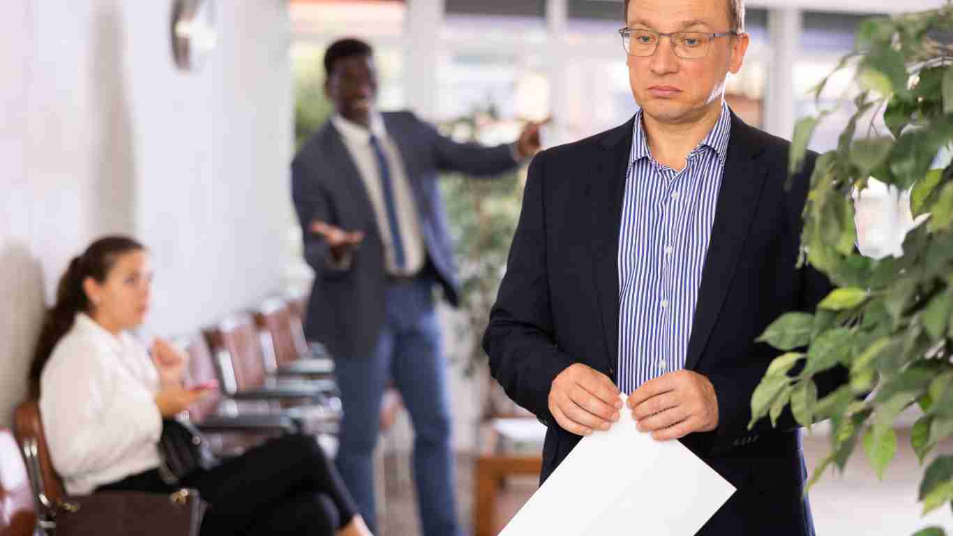 A man screaming at a colleague at the office