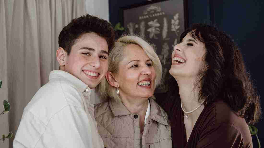 A mother laughing with her children