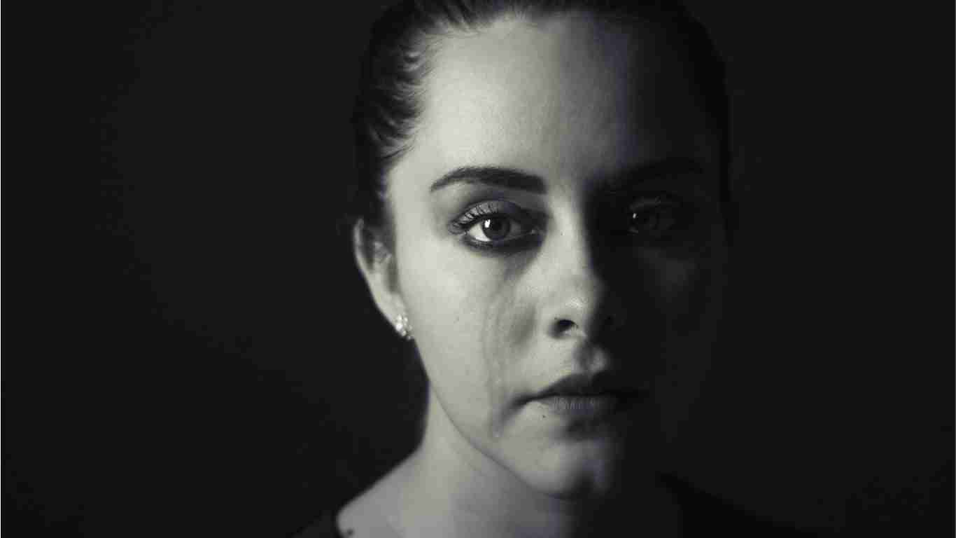A sad woman with tears streaming down her face