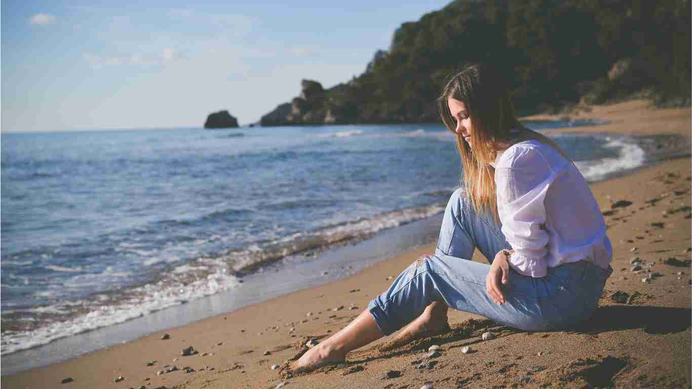 A lonely woman staring out at the sea