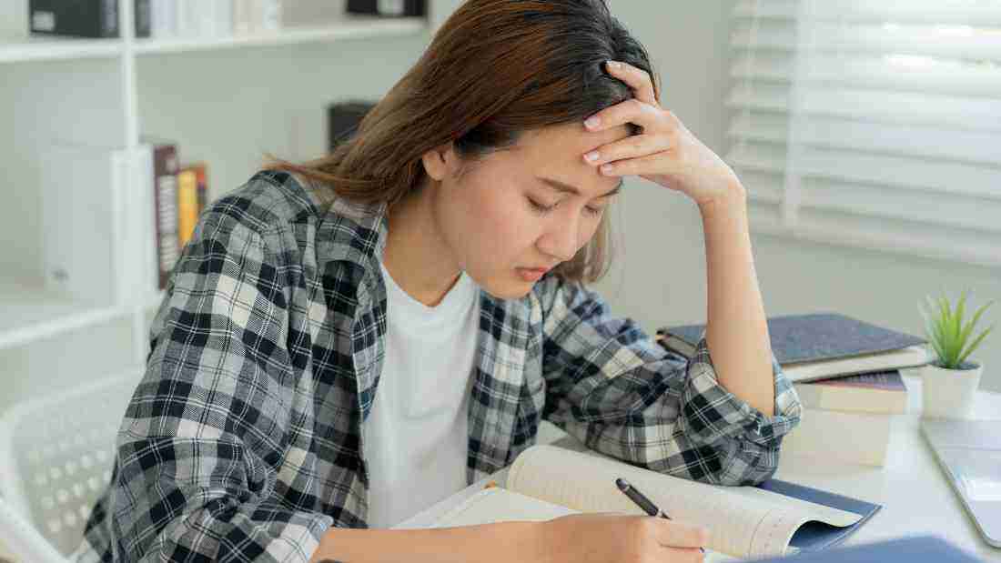 An anxious young woman trying to get her work done