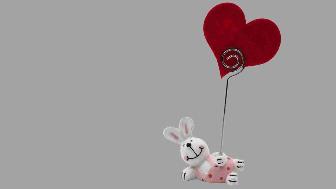 A bunny holding up a red heart