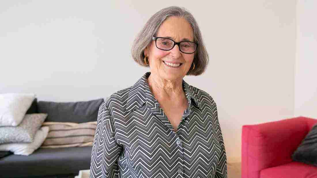 A grey-haired lady smiling