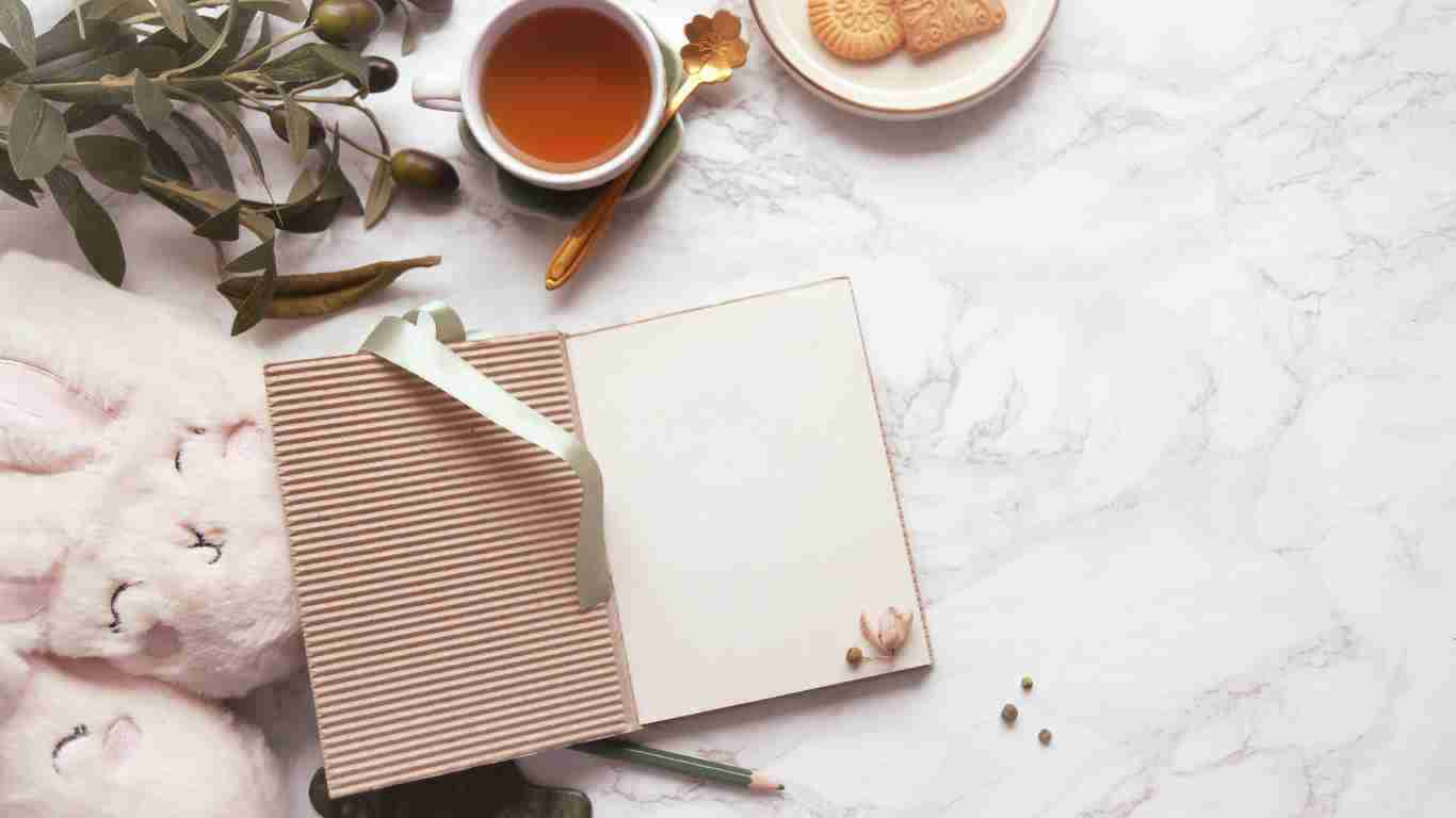 A journal, candles and a cup of coffee