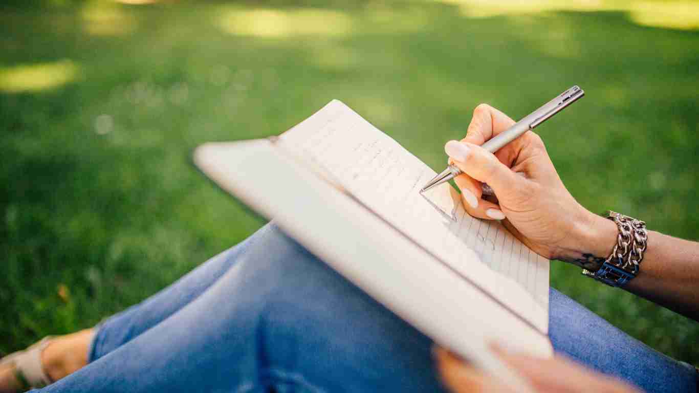 A woman journaling in the park
