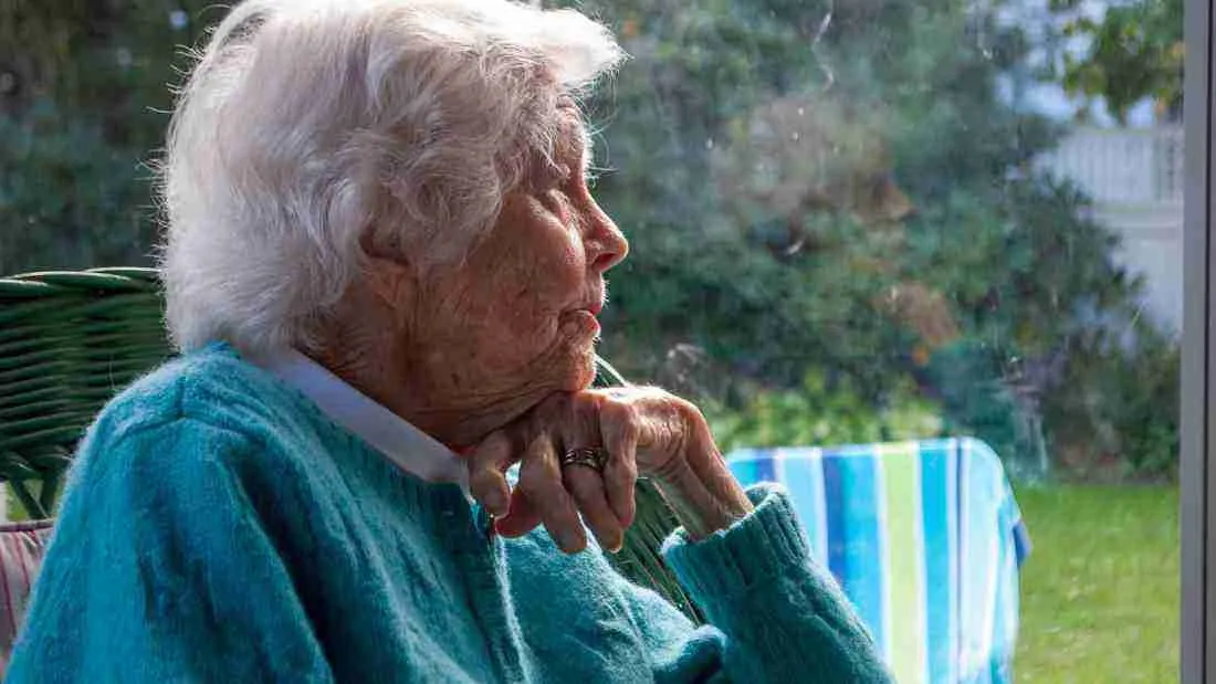 An old woman staring out of the window