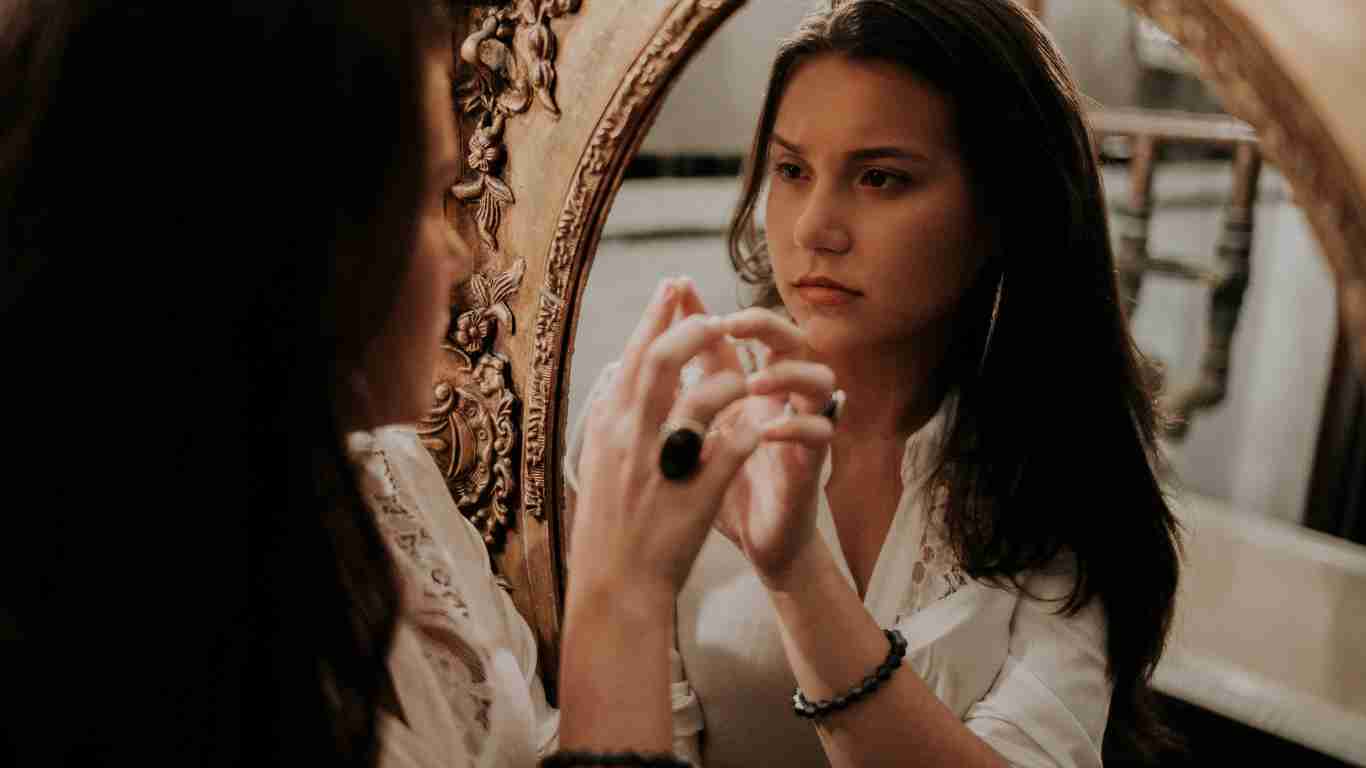 A woman gazing at herself in the mirror