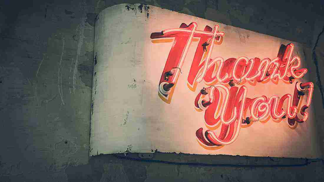 A neon sign that says THANK YOU