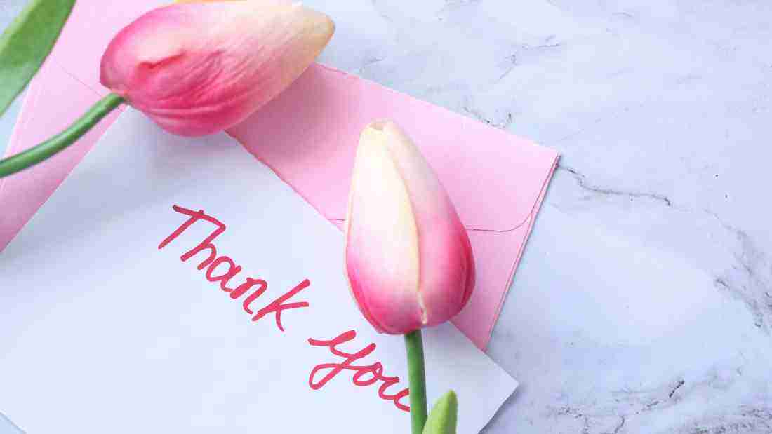 A thank you note and a bunch of pink tulips
