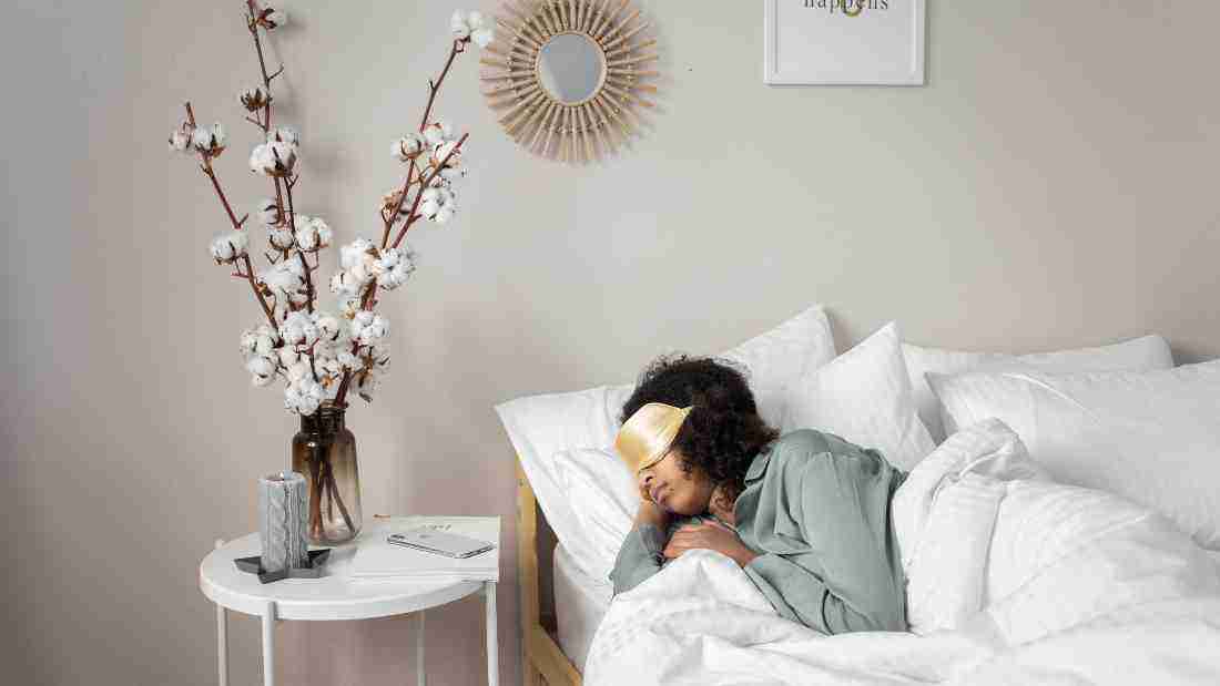 A woman fast asleep in bed