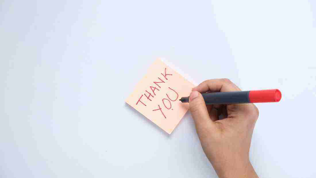 A woman writing a thank you note