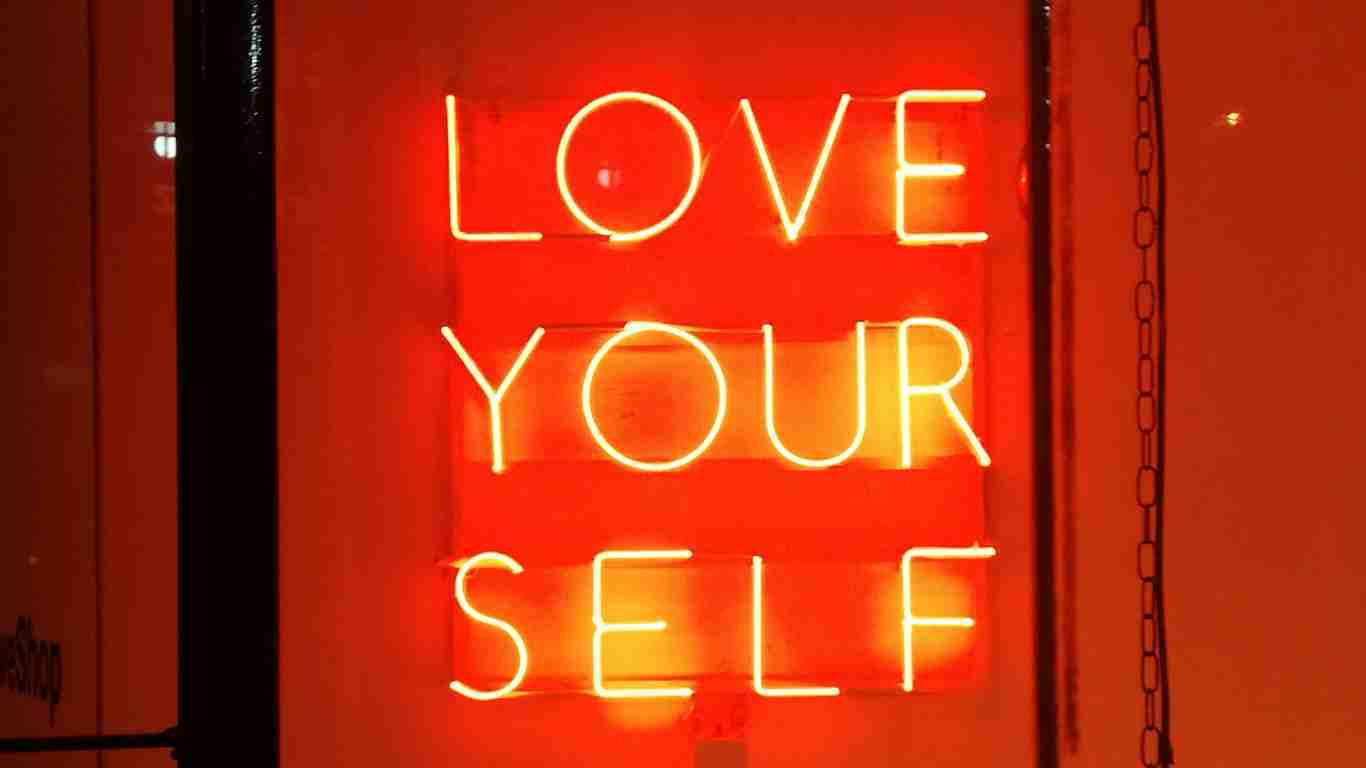A neon sign saying Love Yourself