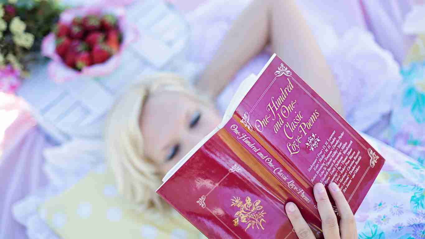 A woman reading a poetry book about self love