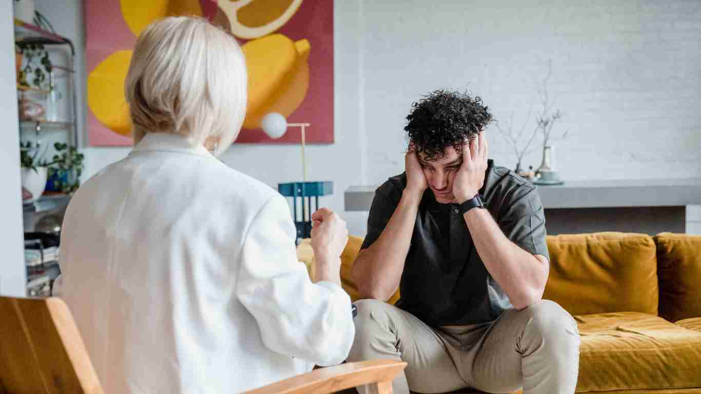 A distressed man talking to his therapist