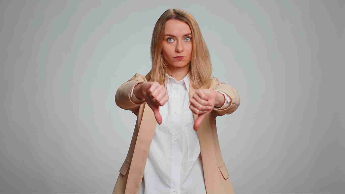 A woman dismissing someone by giving them a fingers down