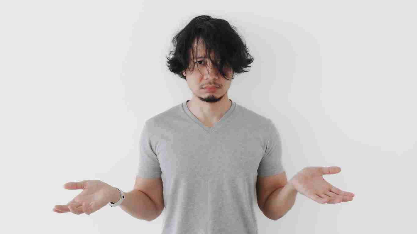 A man opening his arms to indicate that he does not have a solution
