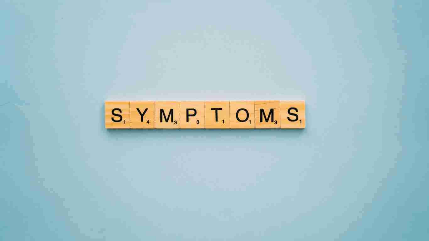 Wooden blocks forming the word SYMPTOMS